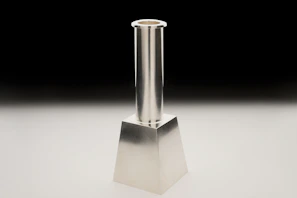 A sleek candlestick chart with gold and emerald highlights on a deep navy background