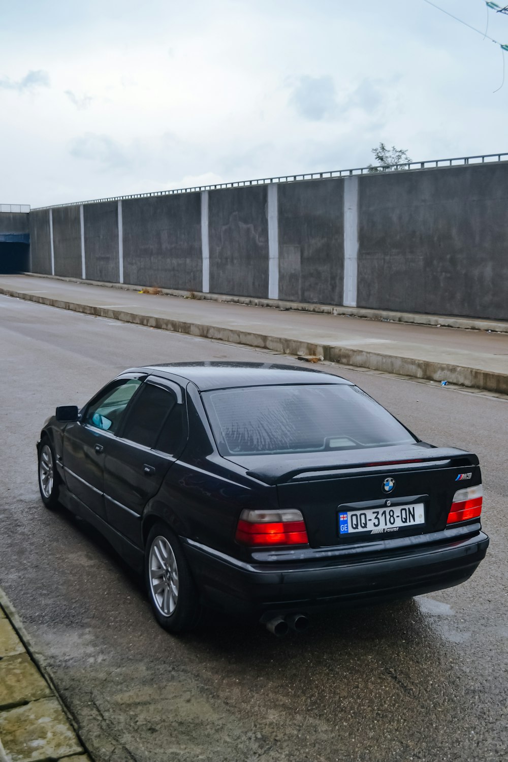 a black car parked on the side of the road