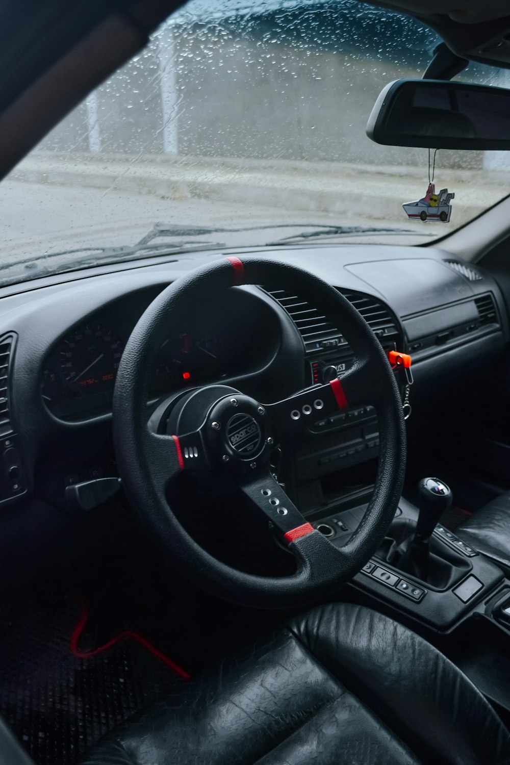 the interior of a car with a steering wheel and dashboard