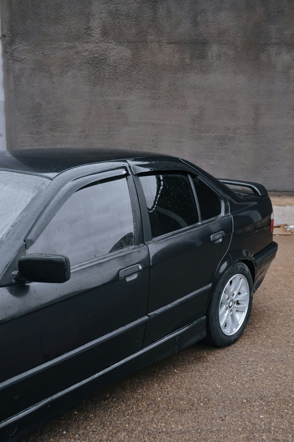 a black car parked in front of a building