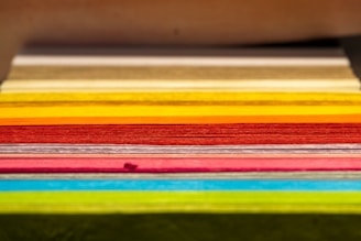 Close-up of colorful printed materials neatly stacked, showcasing quality and variety.