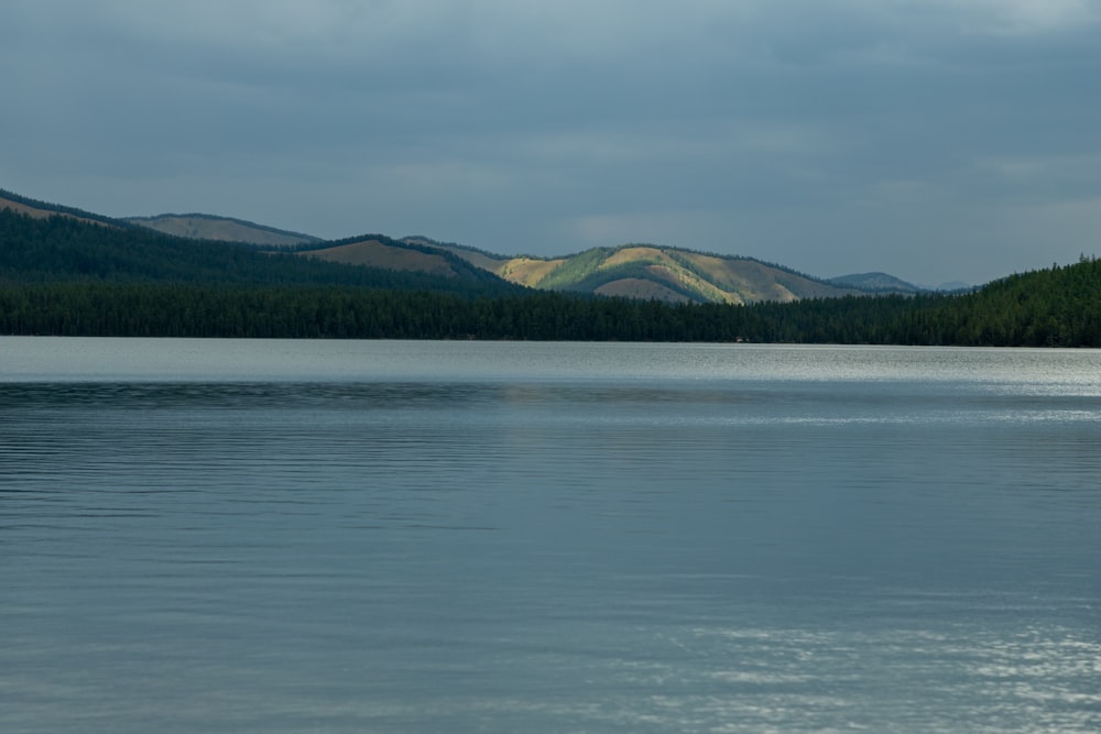 a large body of water with mountains in the background