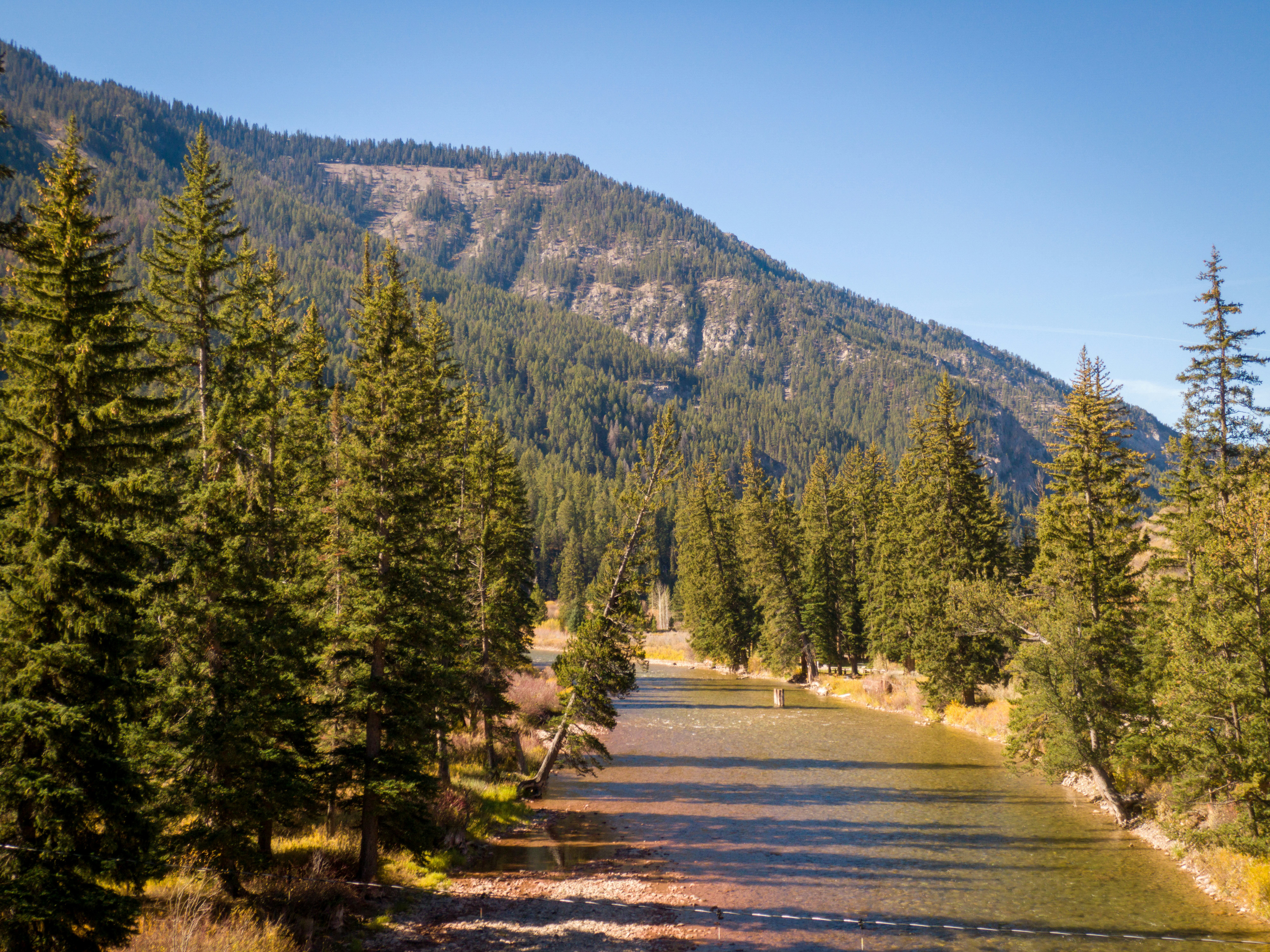 Panoramic view of the West of Jackson neighborhood with the Teton Mountains in the background, showcasing stunning homes and natural landscapes.