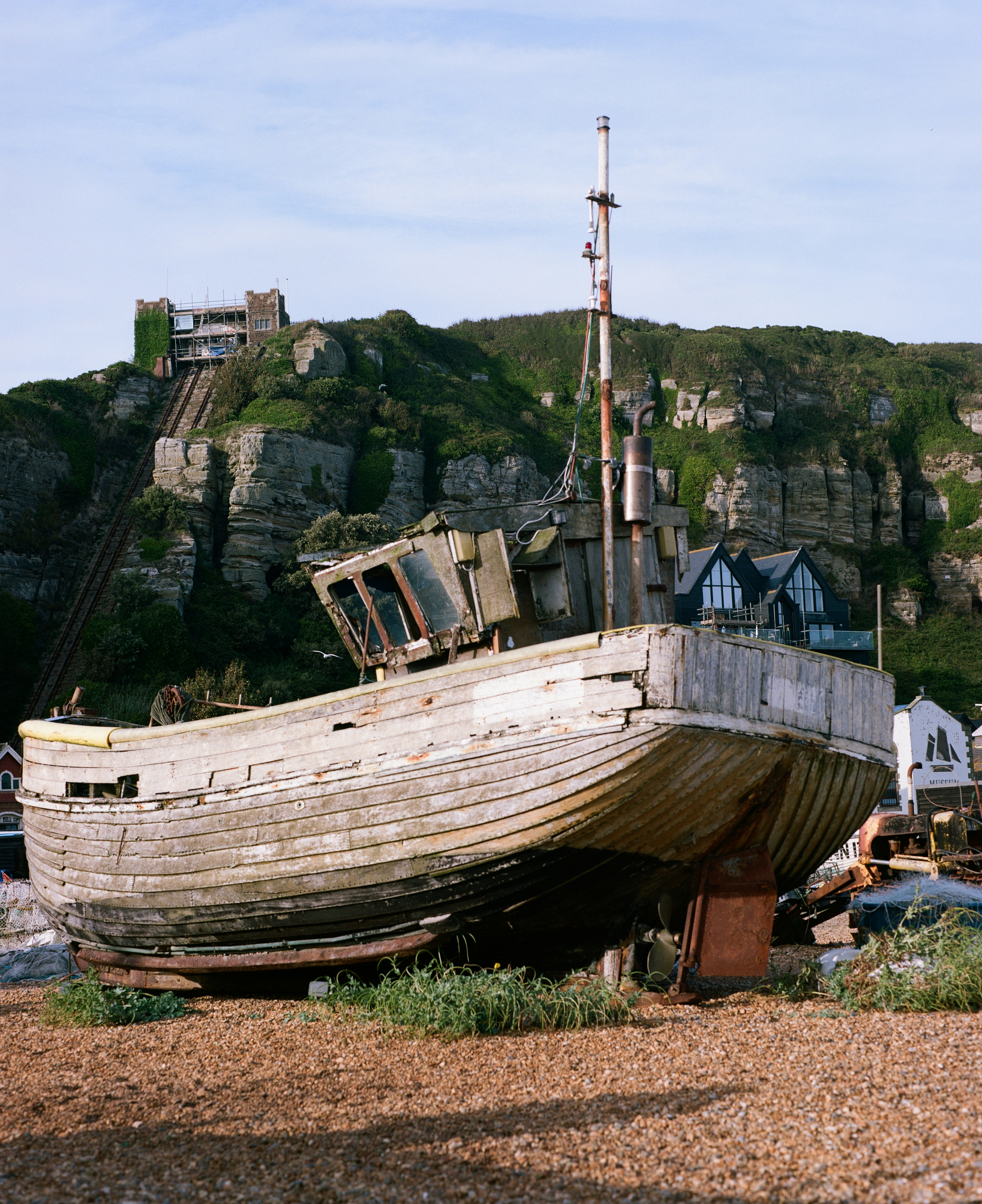 an old wooden boat sitting on top of a beach