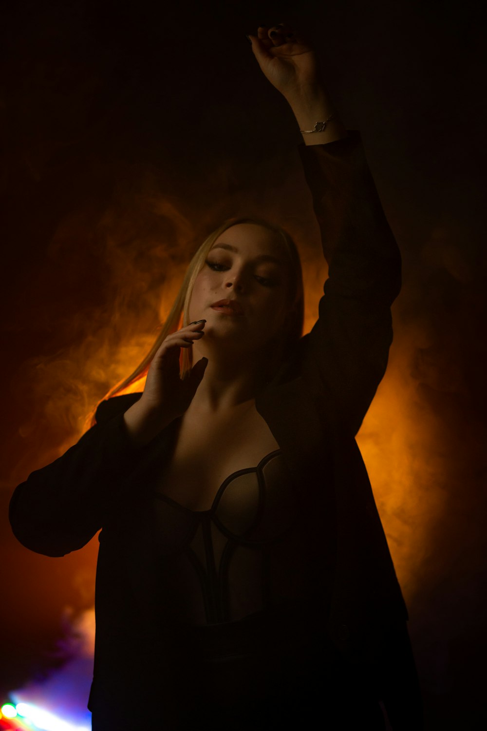 a woman smoking a cigarette in the dark