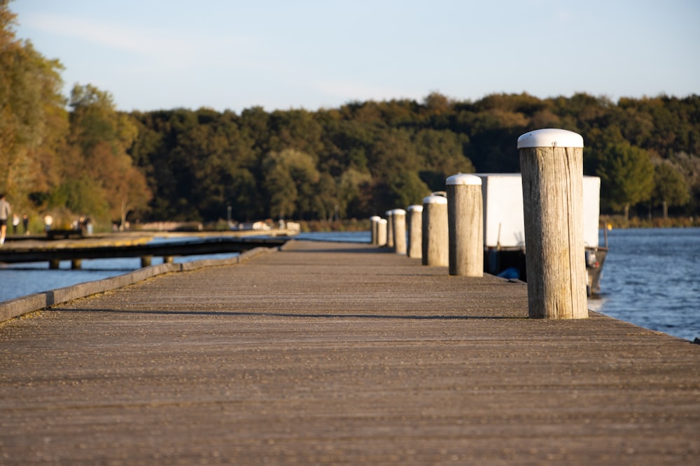 a wooden dock with a boat in the water