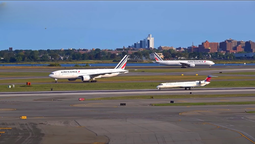 a couple of airplanes that are on a runway