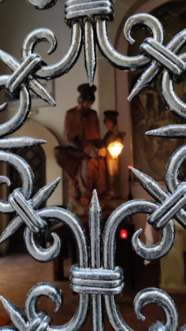 Close-up of a custom folding gate made of polished metal with intricate detailing.