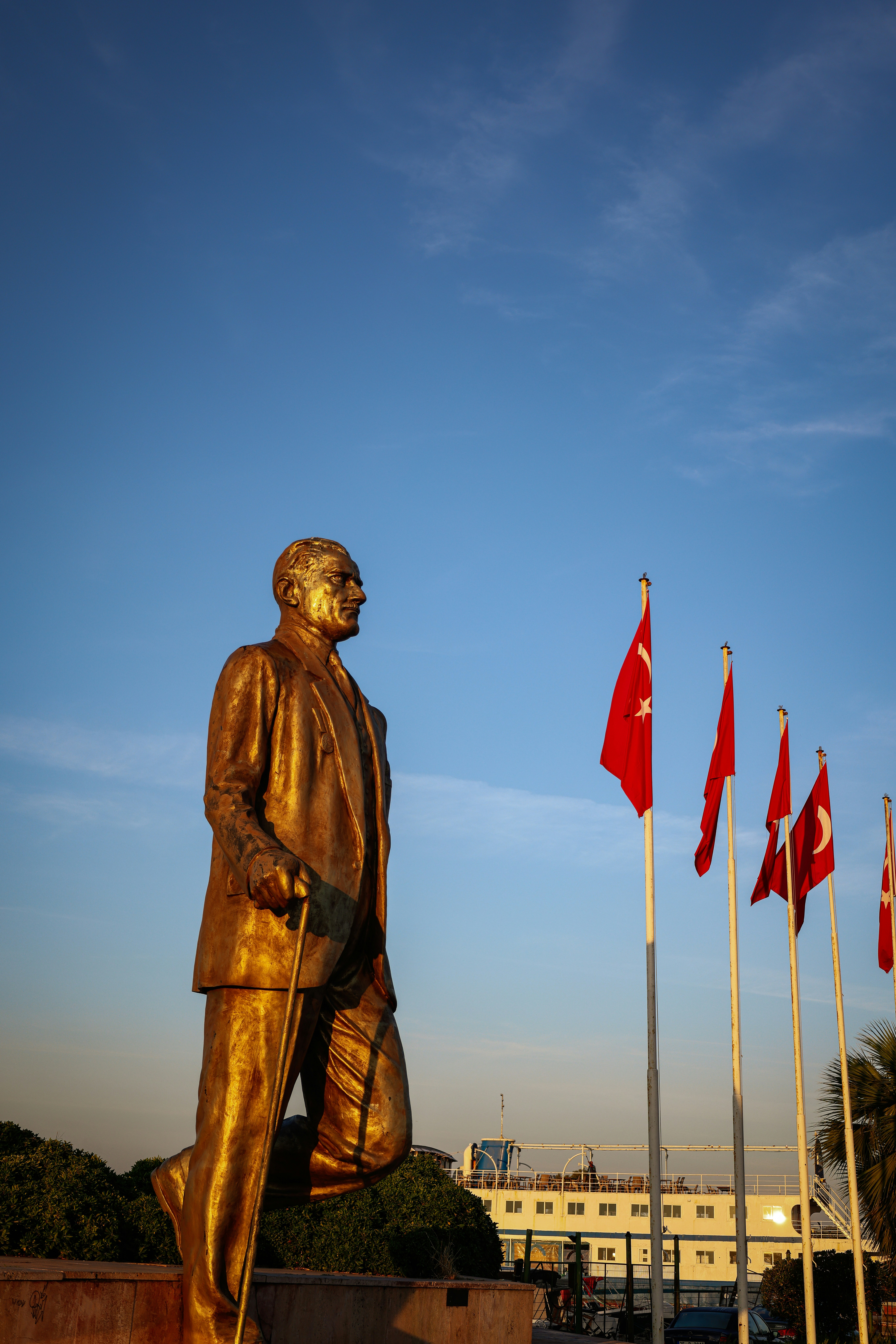 旗の前で杖をついた男の像