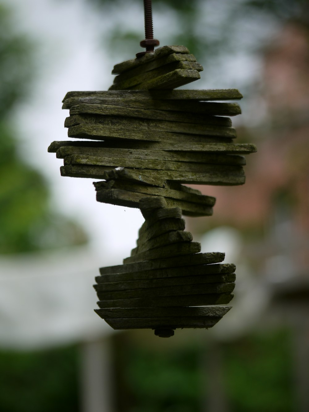 a wooden wind chime hanging from a wire