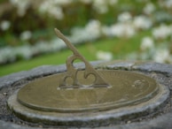 Close-up of an ancient sundial casting shadows to mark time.