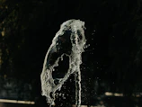 Dynamic mid-air kick frozen in time against a dark background.