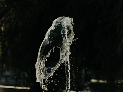 Dynamic mid-air kick frozen in time against a dark background.