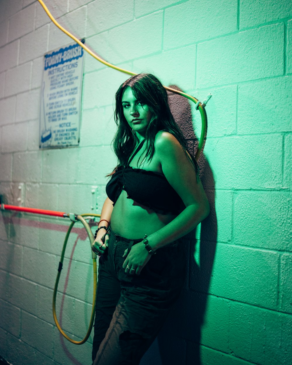 a woman standing in a room with a hula hoop