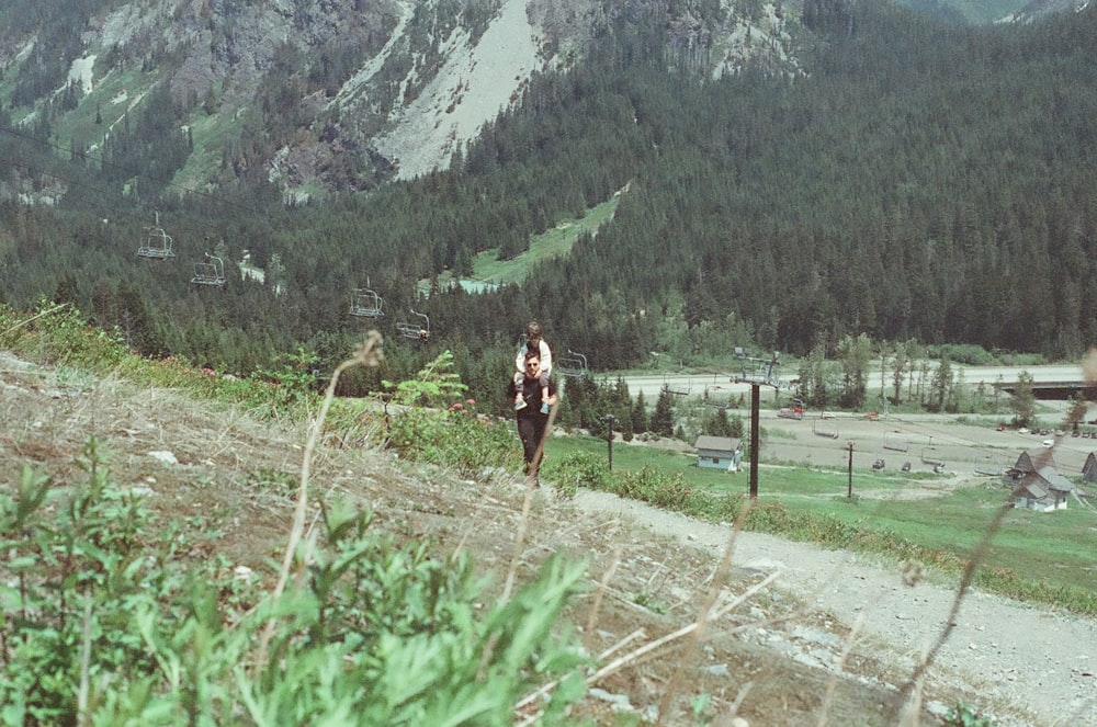 a person walking up a trail in the mountains