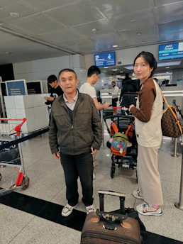 A vibrant airport scene with travelers checking flight boards and suitcases ready.