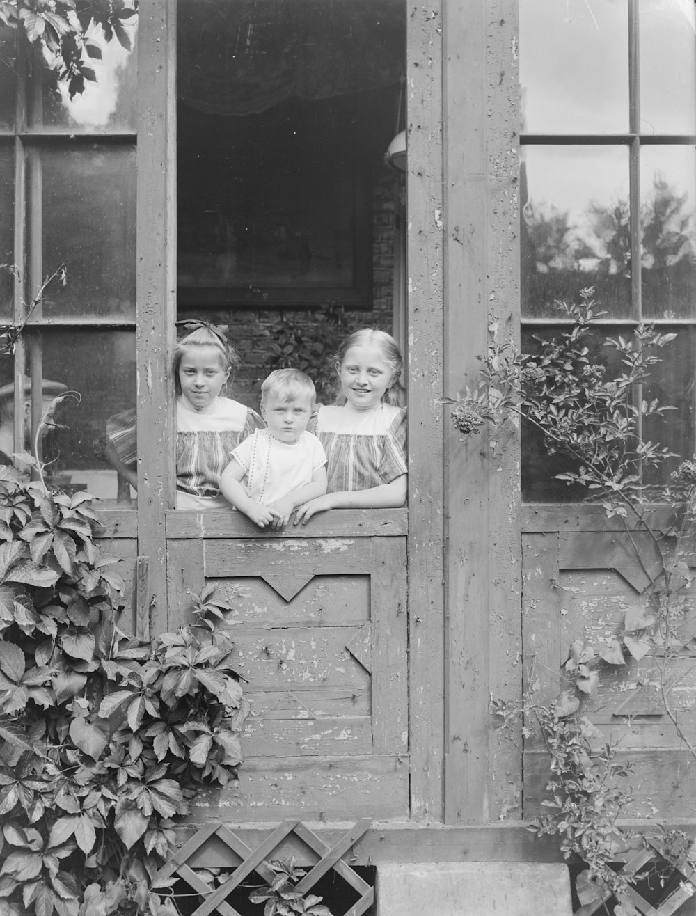 a group of young girls sitting on top of a window sill