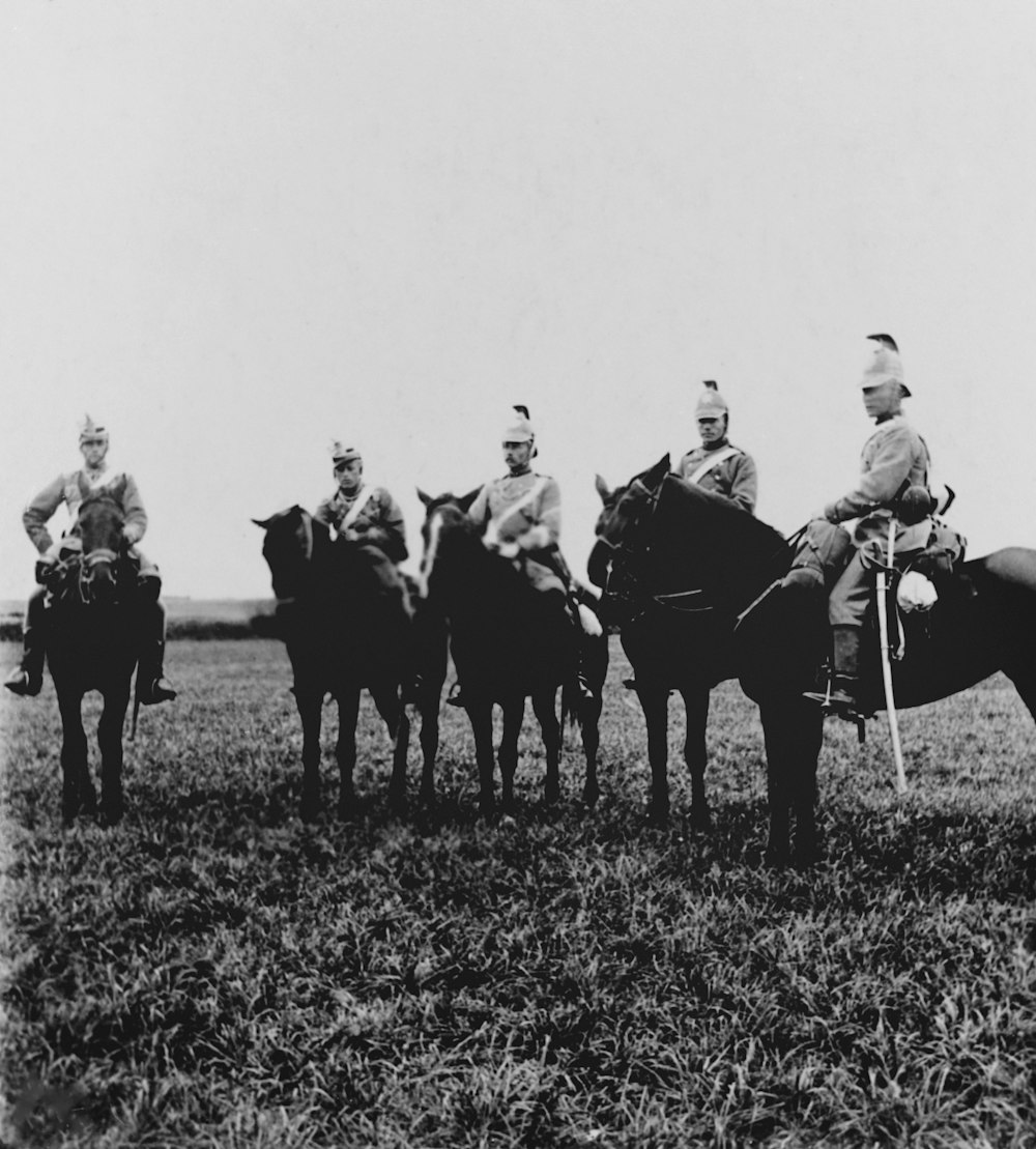 a group of men riding on the backs of horses