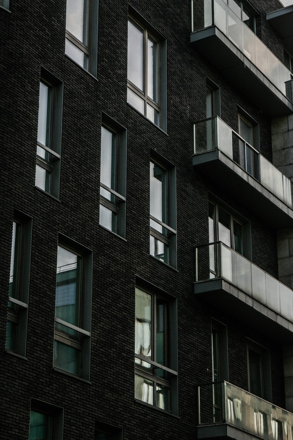 a tall building with lots of windows and balconies