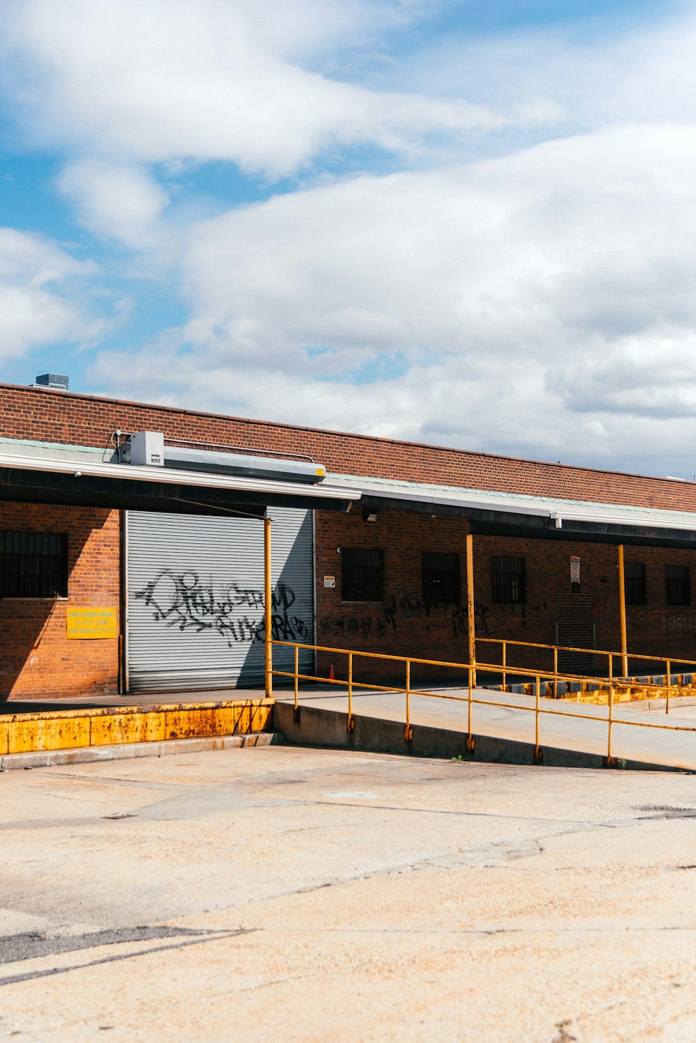 a train station with graffiti on the side of it