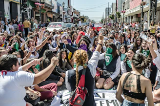 a large group of people sitting in the street