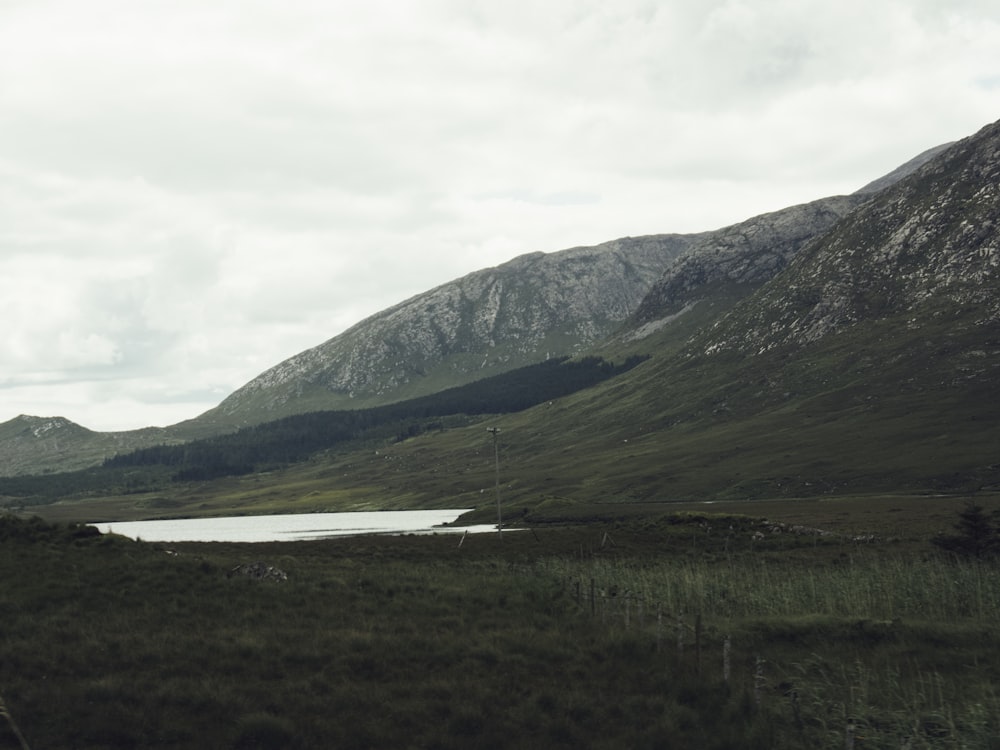 a mountain range with a lake in the foreground