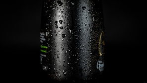 Close-up of a glamever facewash bottle with fresh water droplets on the surface