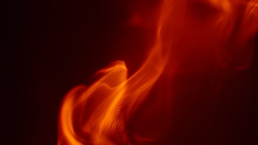 a close up of a red fire with a black background