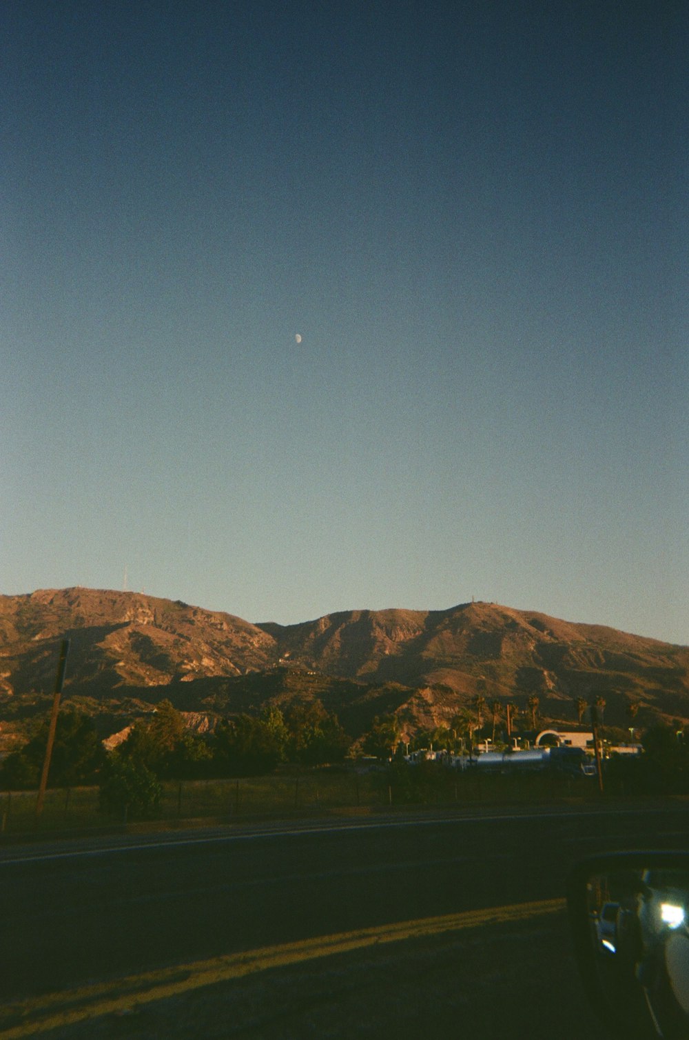 a view of a mountain range from a car window