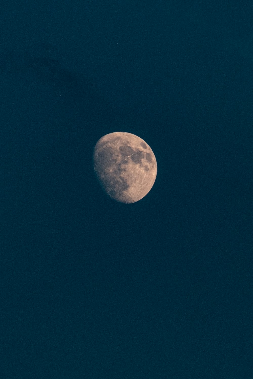 a full moon in a dark blue sky