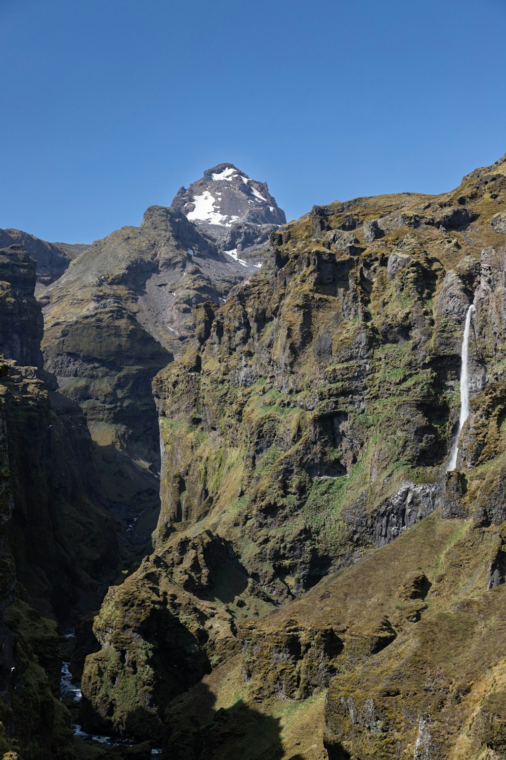 a mountain with a waterfall in the middle of it