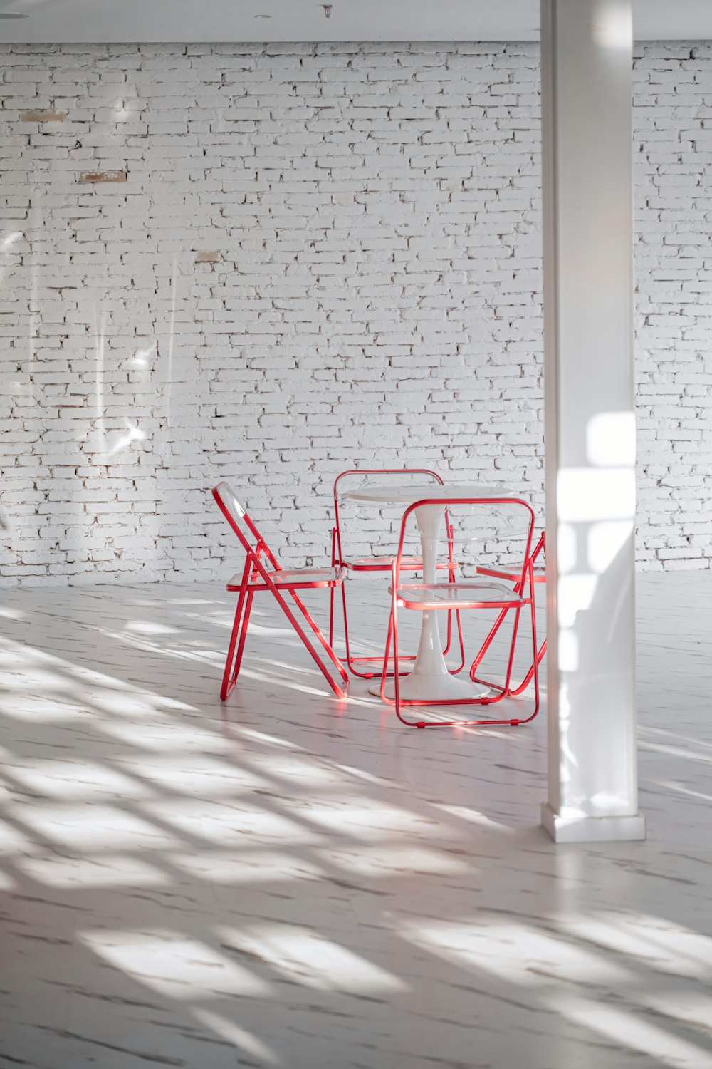 a red chair sitting on top of a white floor