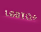 Glossy, multicolored letters spelling 'LGBTQ+' stand out against a solid magenta background. The letters have a reflective, shiny texture, creating a kaleidoscope effect with various shades.