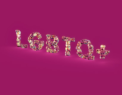 Glossy, multicolored letters spelling 'LGBTQ+' stand out against a solid magenta background. The letters have a reflective, shiny texture, creating a kaleidoscope effect with various shades.