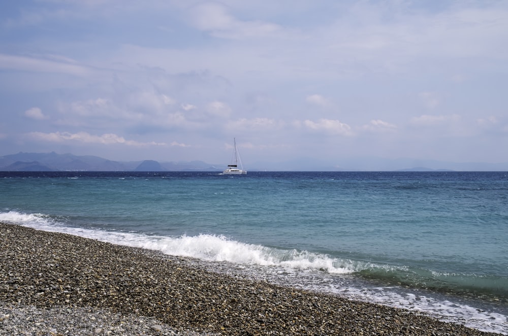 a boat is out on the water near the shore