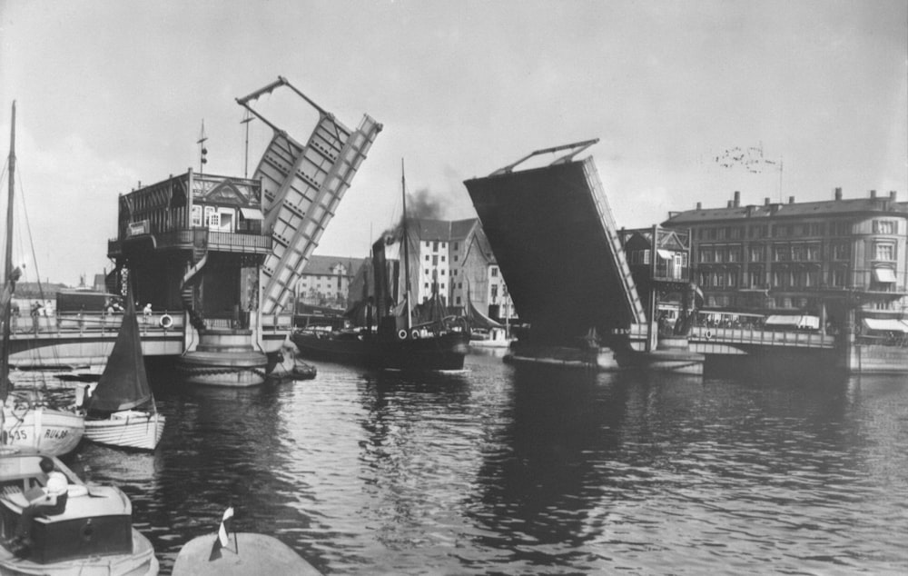a black and white photo of boats in a harbor