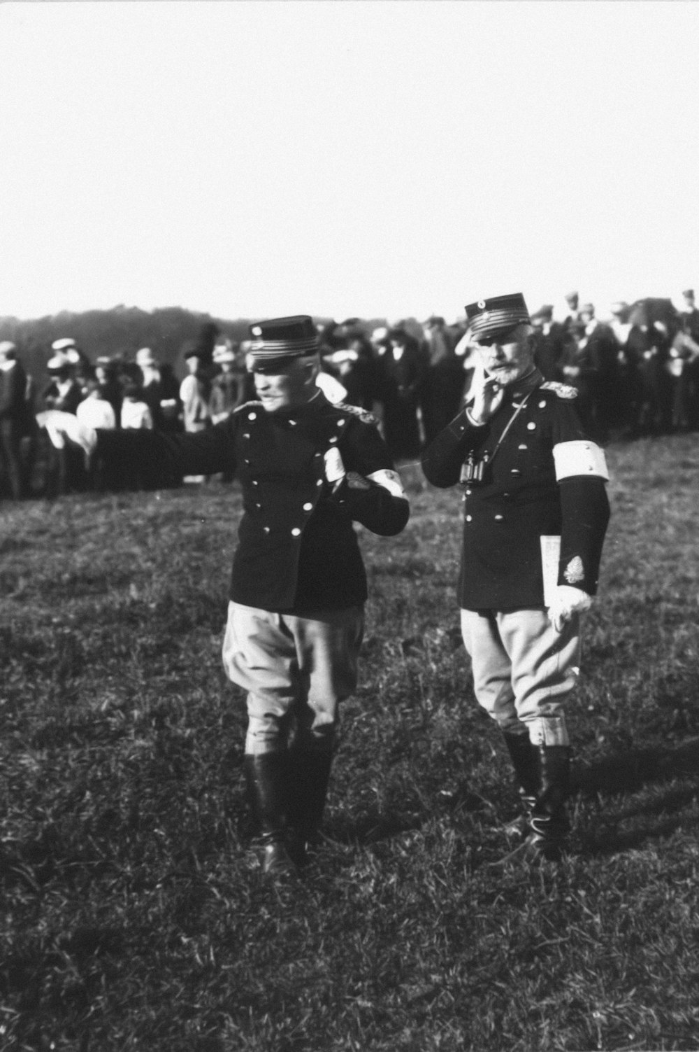 a couple of men standing next to each other in a field