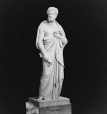 a black and white photo of a statue of a man