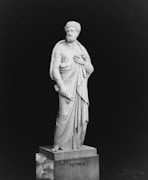 a black and white photo of a statue of a man
