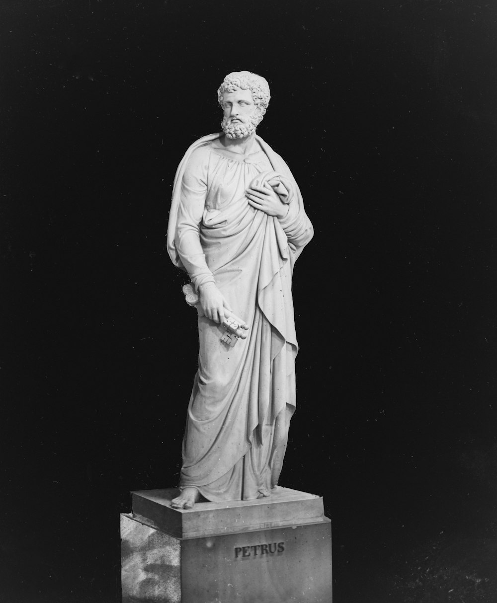 a black and white photo of a statue of a man