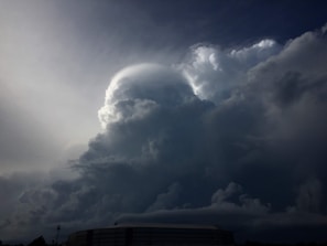 The dark silhouette of the one tower looming ominously against a stormy horizon.