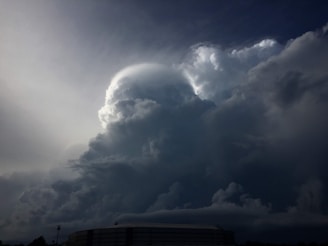 The dark silhouette of the one tower looming ominously against a stormy horizon.