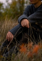 a person sitting in a field of tall grass