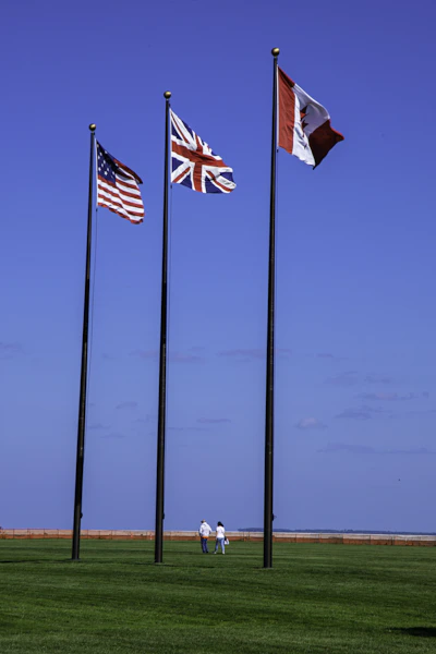 a group of three flags flying next to each other