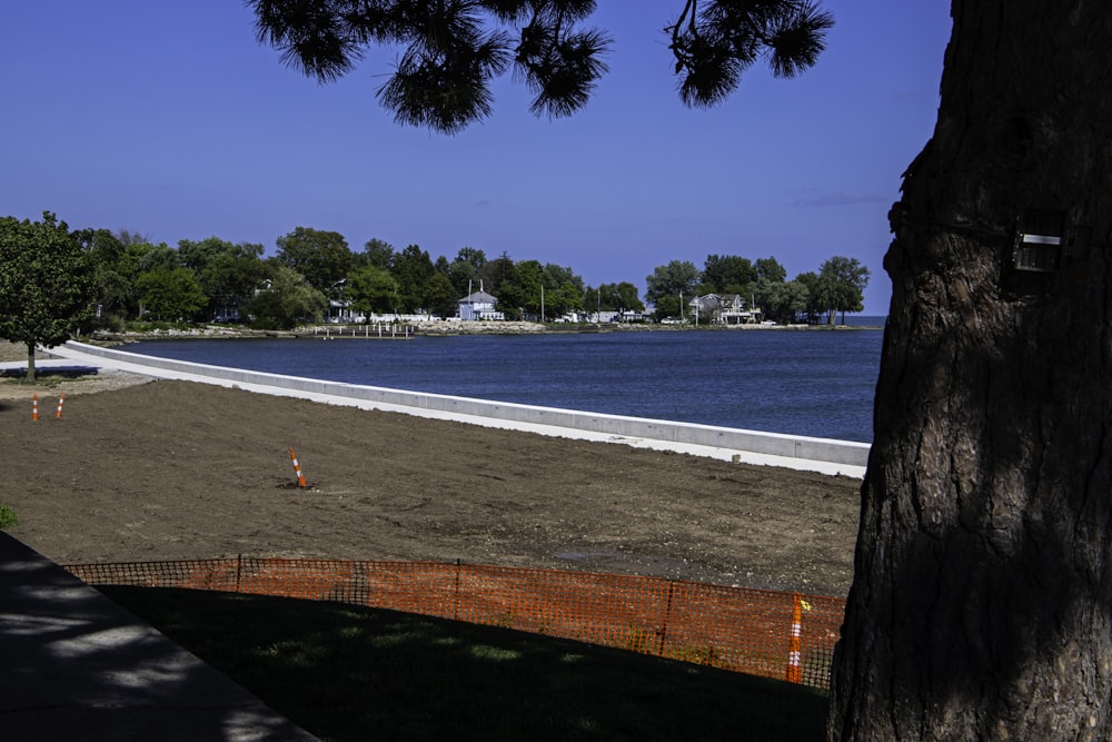 a large body of water sitting next to a sandy beach