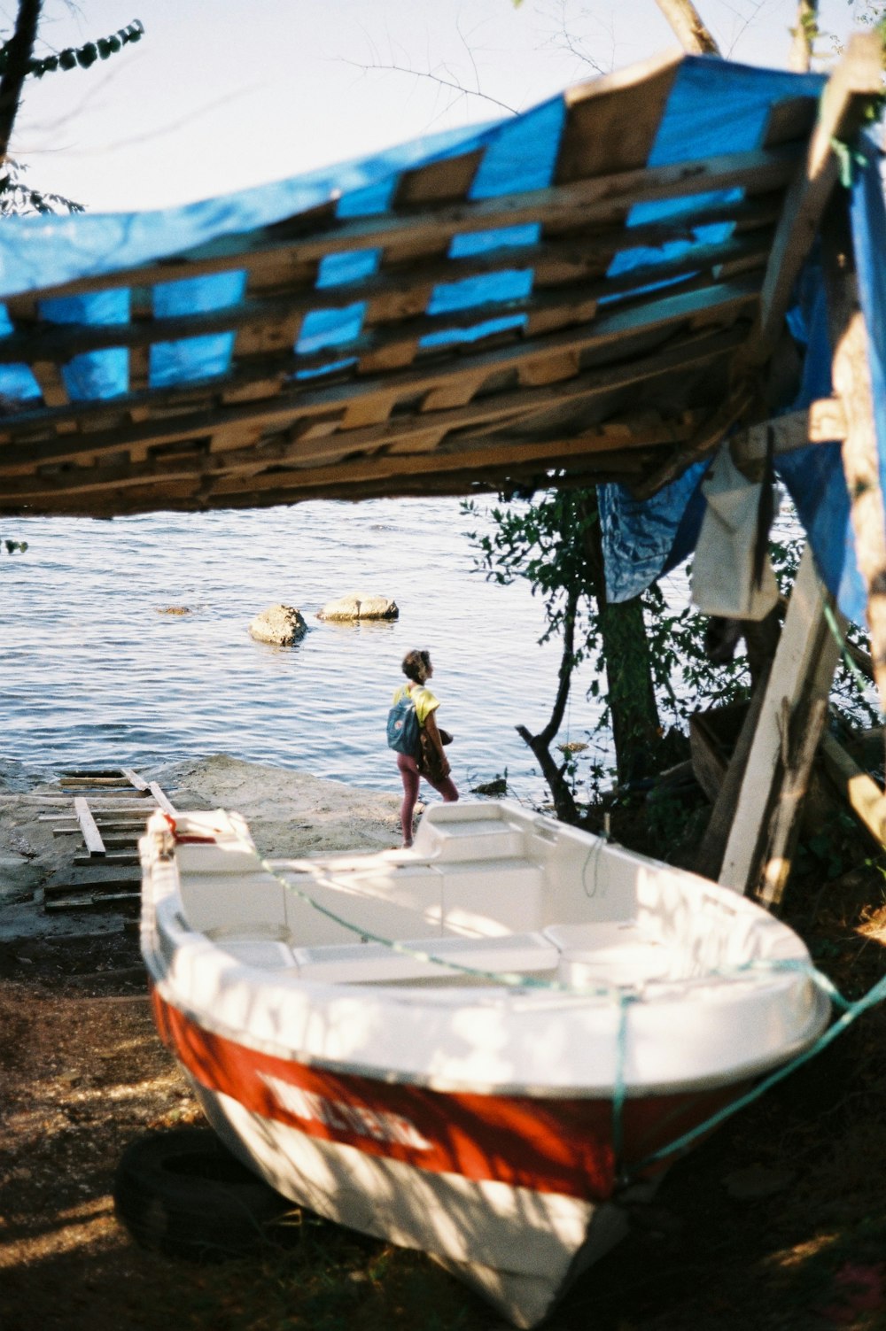 a boat sitting on the shore of a lake