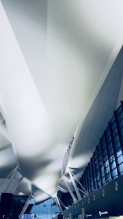 Close-up of futuristic terminal architecture blending glass and steel with natural light.