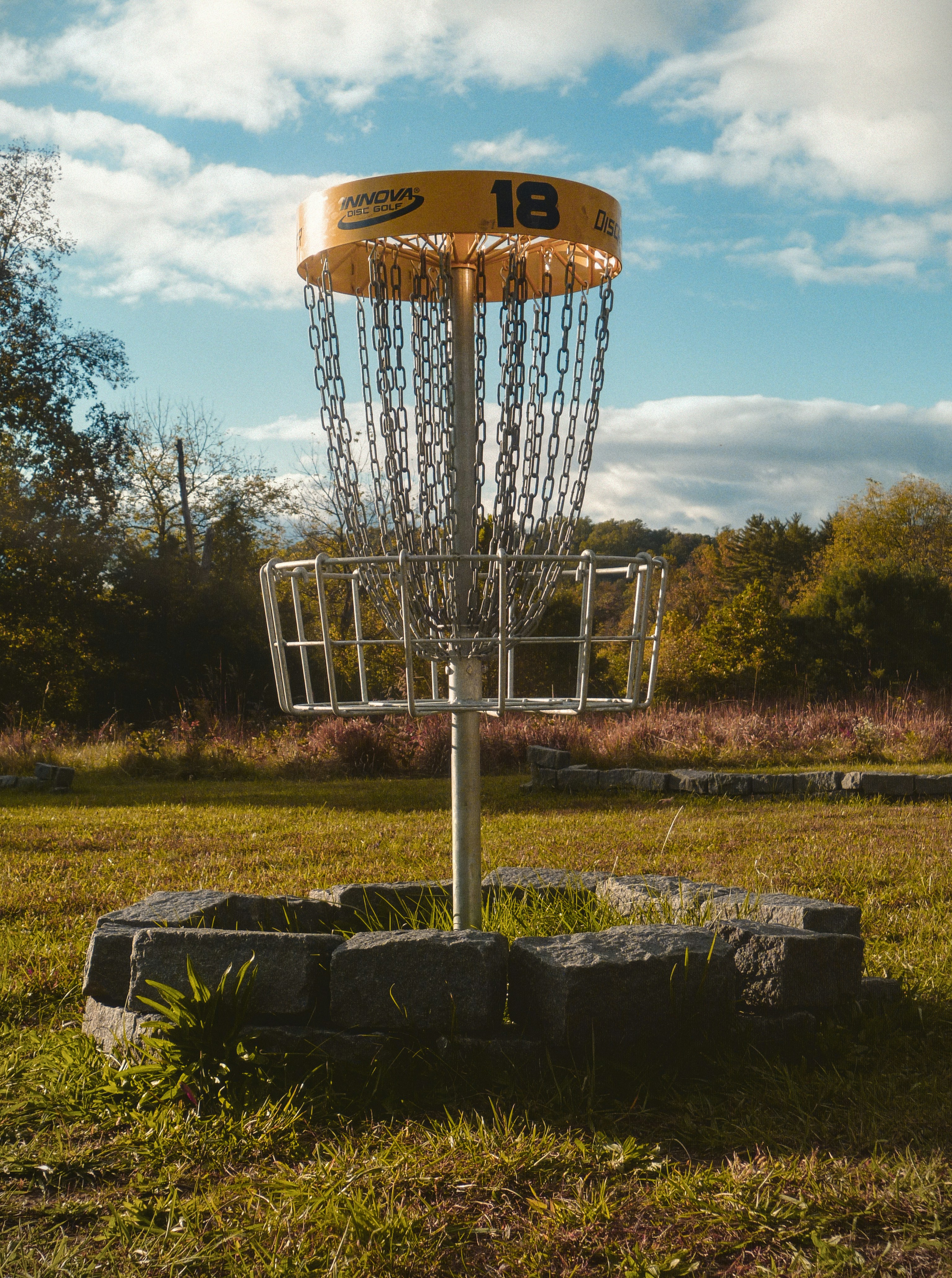 A frisbee golf basket in a grassy field photo Free Outdoors Image on