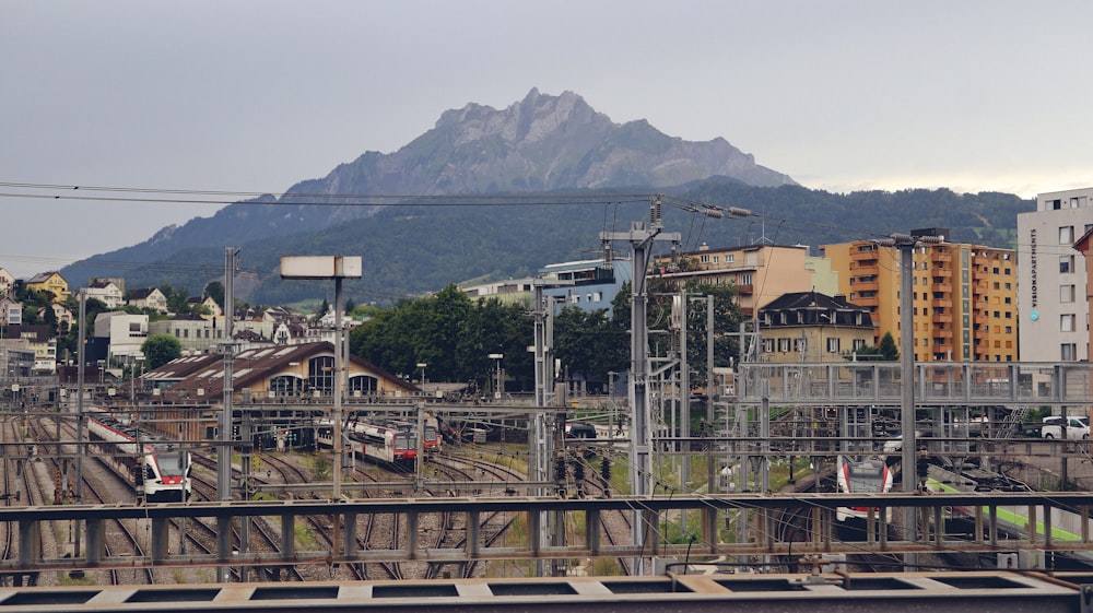 a train station with a mountain in the background