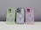Three phone cases are displayed on a neutral background. The left case has a neon green border, the middle case contains a phone and has a gray border, while the right case features a pink border. Each case has a circular design in the center.